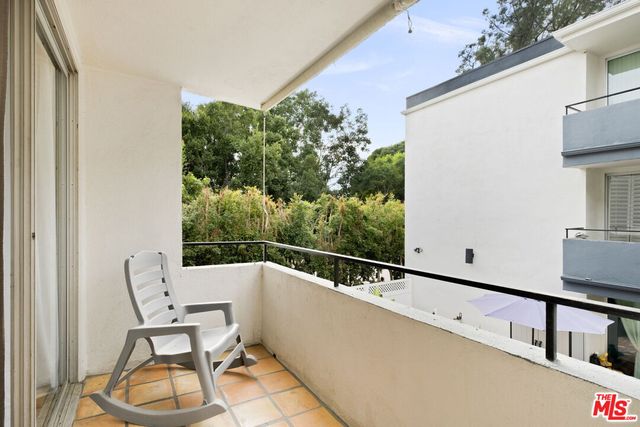 a view of a chair and tables in the balcony