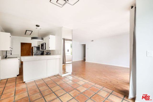 a view of a kitchen with wooden floor