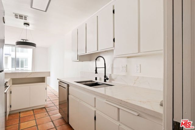 a kitchen with a sink and cabinets