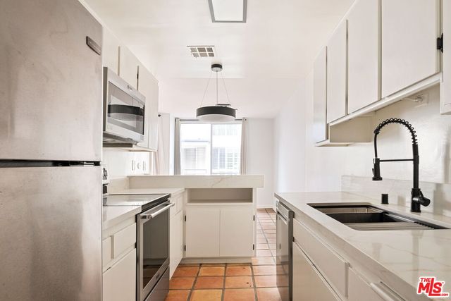 a kitchen with a sink stove and refrigerator