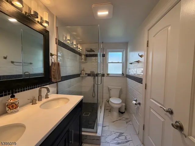 a view of a backyard with plants and a large tree