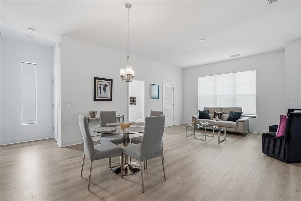 4810 West McElroy Avenue, Unit 30 Tampa, FL 33611 - Photo 11 of 43 a living room with furniture and a chandelier