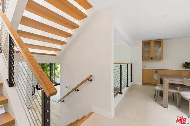 a view of entryway with furniture and stairs