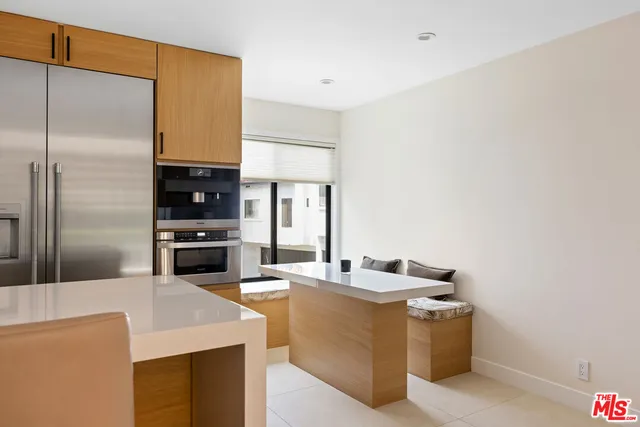 a kitchen with stainless steel appliances a sink a stove and refrigerator