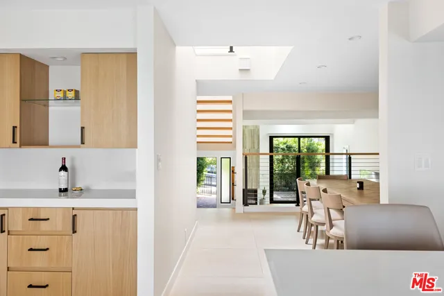 a living room with furniture and large windows