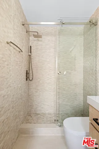 a bathroom with a shower and a bath tub