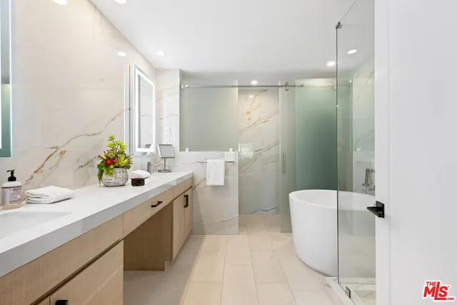 a bathroom with a double vanity sink toilet and a mirror