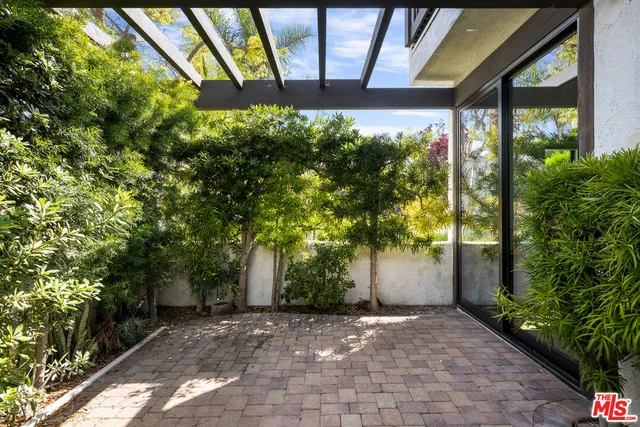 a view of a building with a tree and a yard