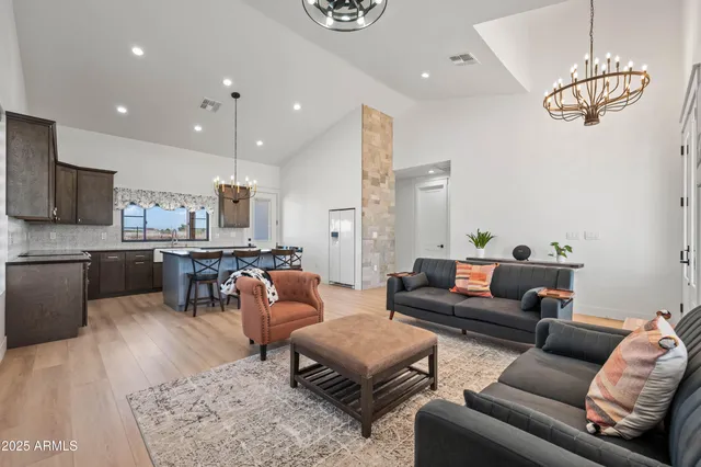 a kitchen with stainless steel appliances kitchen island granite countertop wooden floors and stove