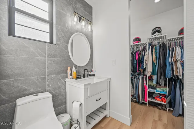 a bathroom with a sink a toilet and a mirror