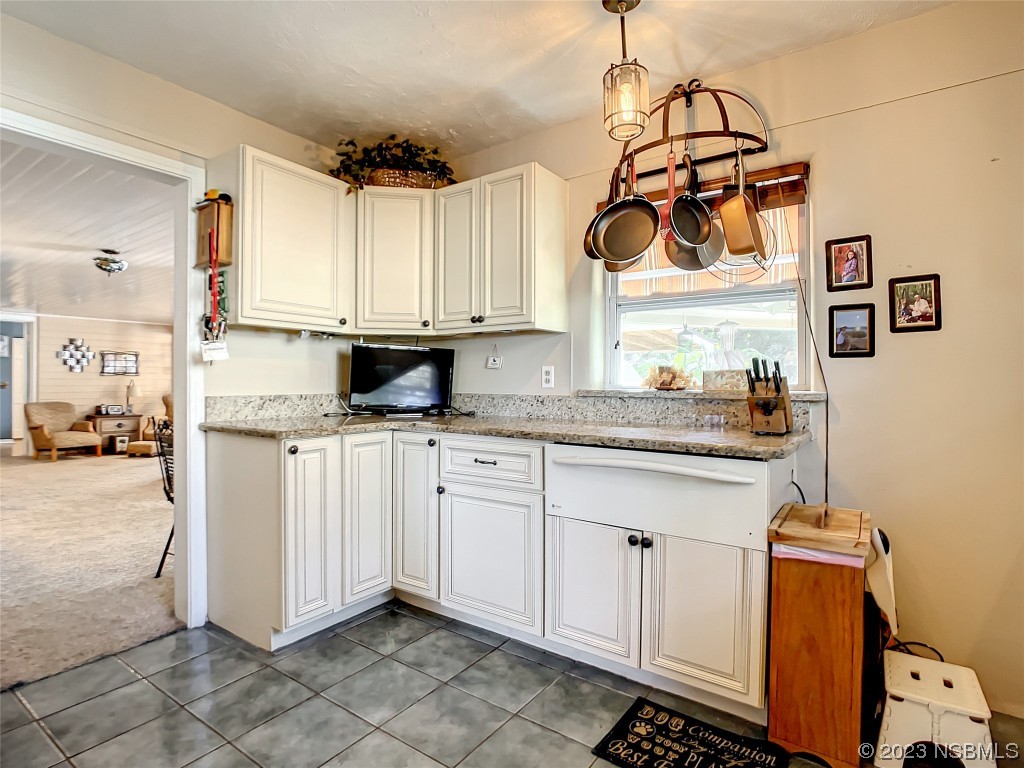 418 North Riverside Drive Edgewater, FL 32132 - Photo 19 of 48 a kitchen with stainless steel appliances granite countertop a sink a stove and a refrigerator