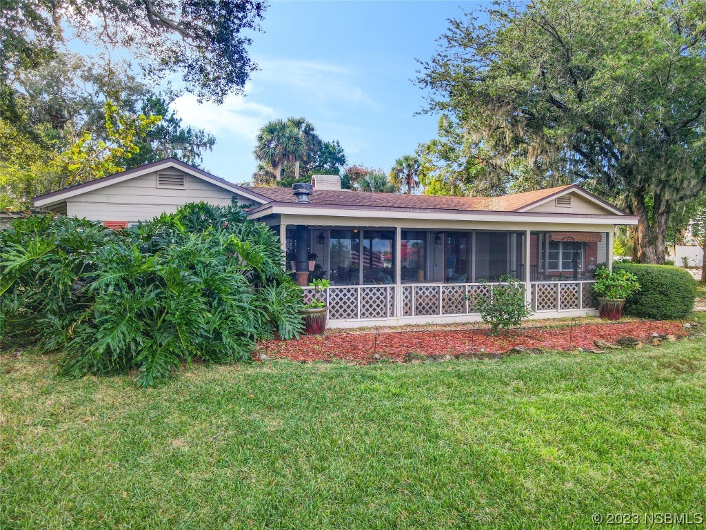 418 North Riverside Drive Edgewater, FL 32132 - Photo 2 of 48 a front view of a house with a yard and porch