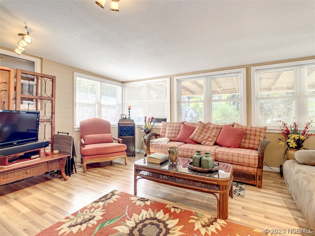 418 North Riverside Drive Edgewater, FL 32132 - Photo 26 of 48 a living room with furniture and a flat screen tv