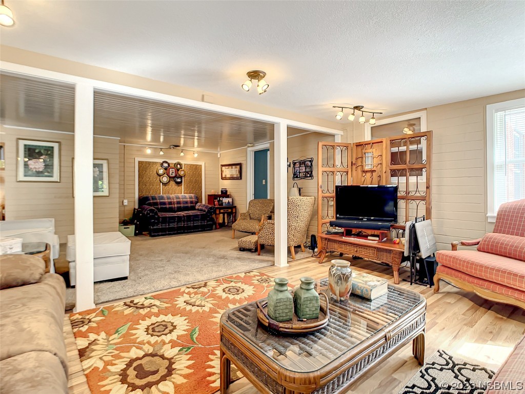 418 North Riverside Drive Edgewater, FL 32132 - Photo 28 of 48 a living room with furniture and a flat screen tv