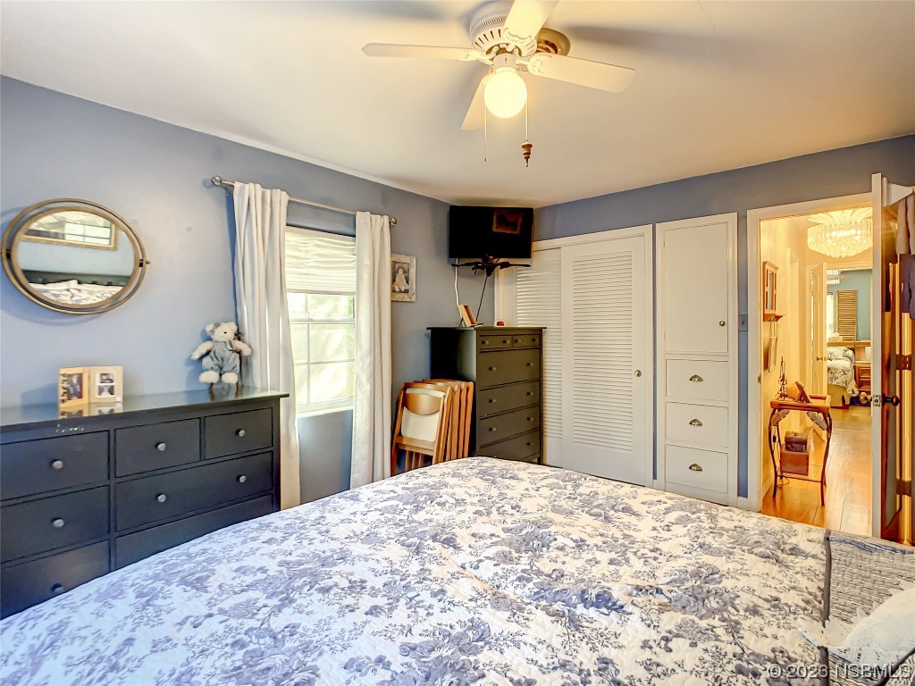 418 North Riverside Drive Edgewater, FL 32132 - Photo 30 of 48 a bedroom with a bed and a dresser