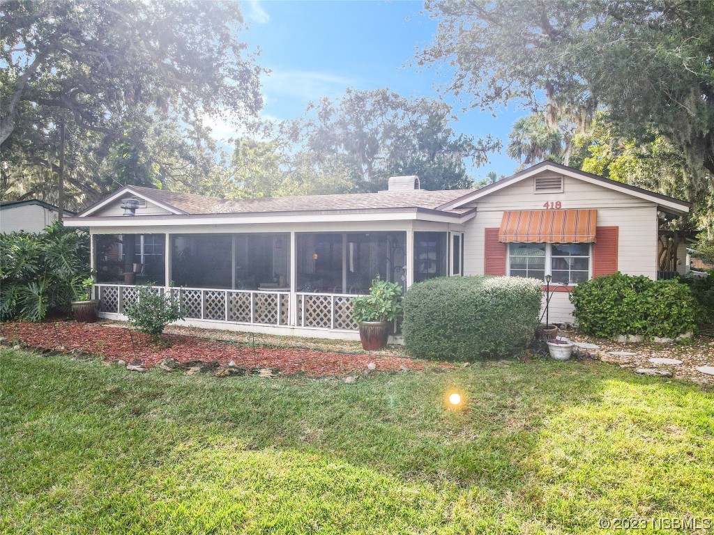 418 North Riverside Drive Edgewater, FL 32132 - Photo 3 of 48 a front view of a house with a yard and porch