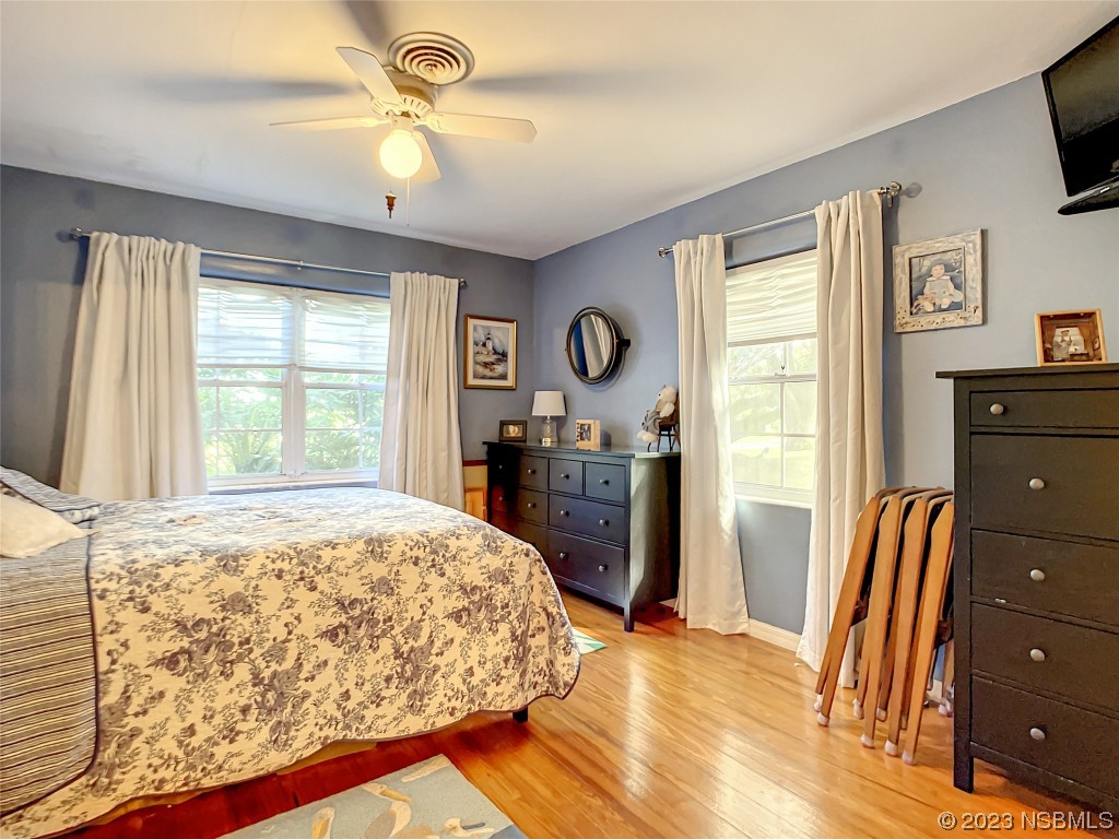 418 North Riverside Drive Edgewater, FL 32132 - Photo 32 of 48 a bedroom with a bed and a flat tv screen on dresser