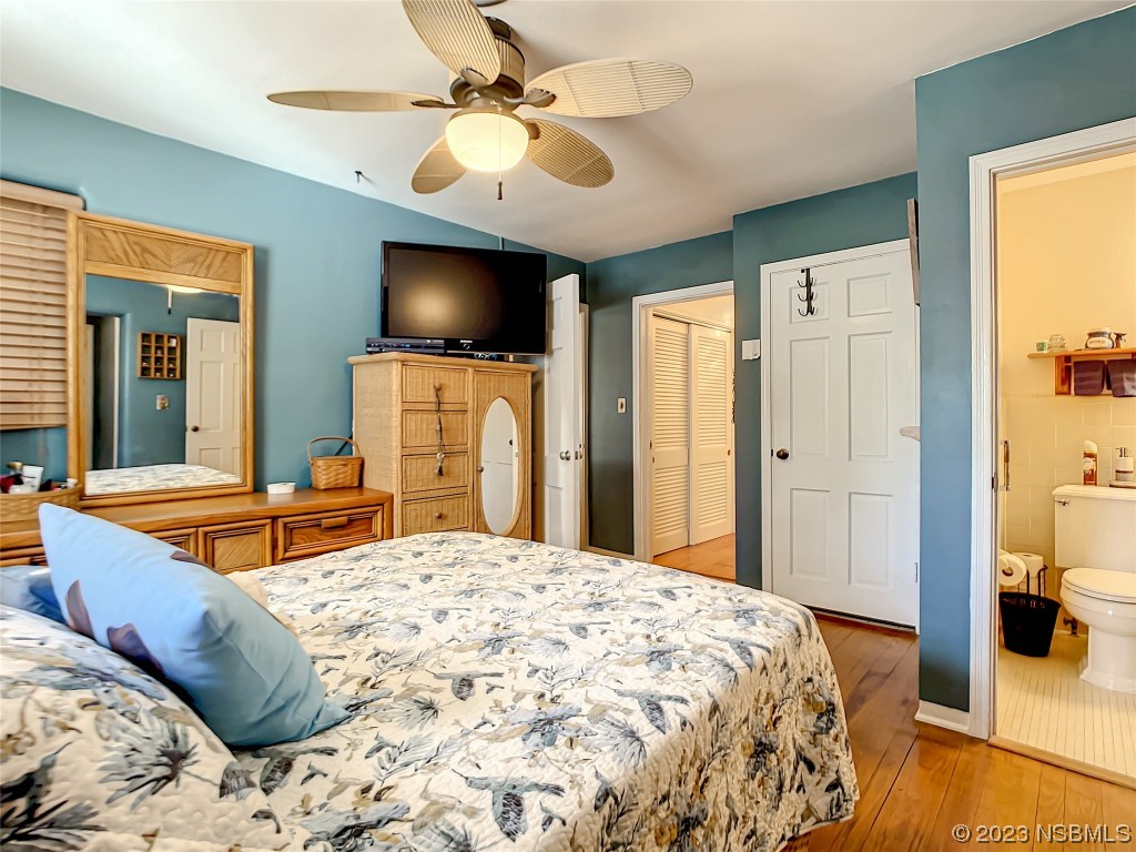 418 North Riverside Drive Edgewater, FL 32132 - Photo 34 of 48 a bedroom with a bed and a flat screen tv