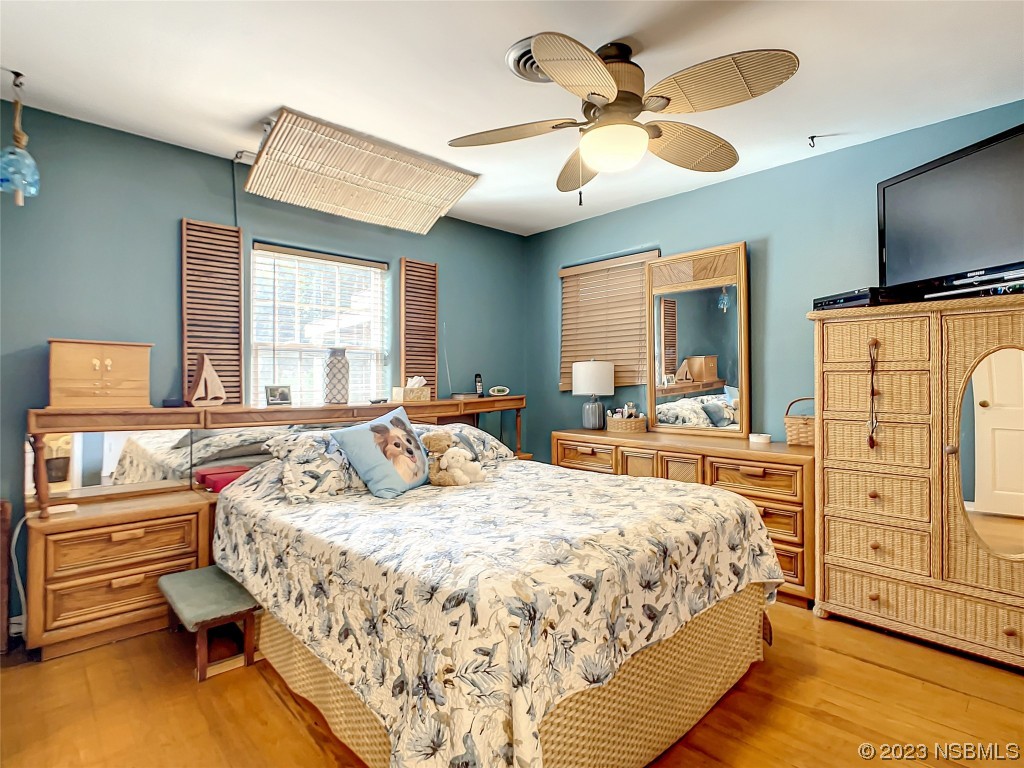 418 North Riverside Drive Edgewater, FL 32132 - Photo 35 of 48 a bedroom with a bed and a flat tv screen on dresser