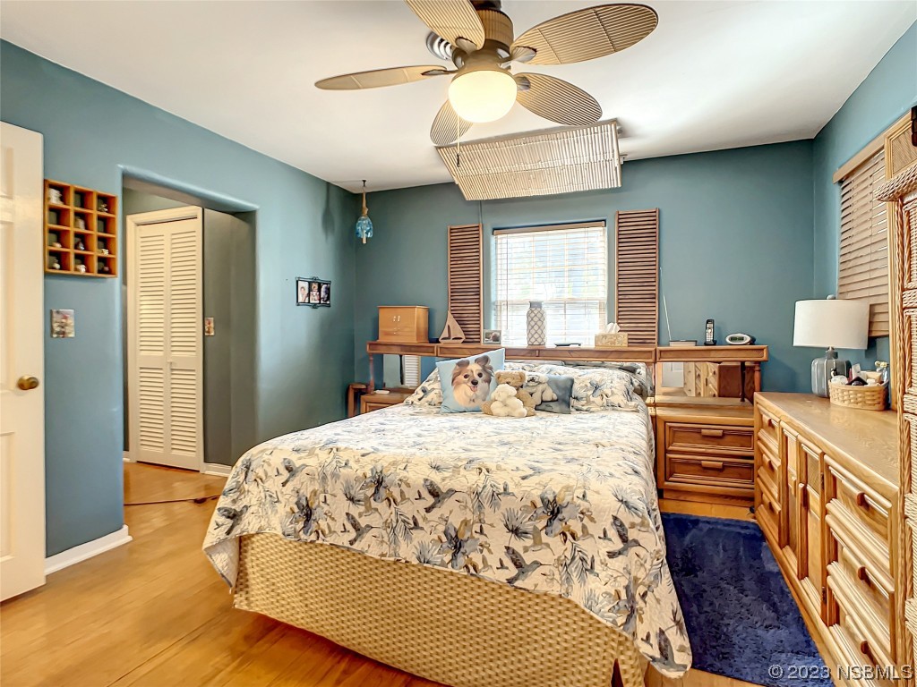 418 North Riverside Drive Edgewater, FL 32132 - Photo 36 of 48 a bedroom with a bed and wooden floor