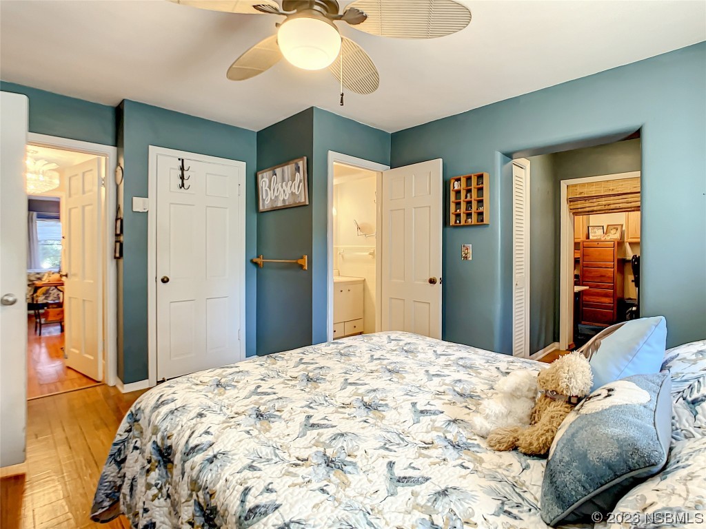 418 North Riverside Drive Edgewater, FL 32132 - Photo 37 of 48 a bedroom with a large bed and chandelier