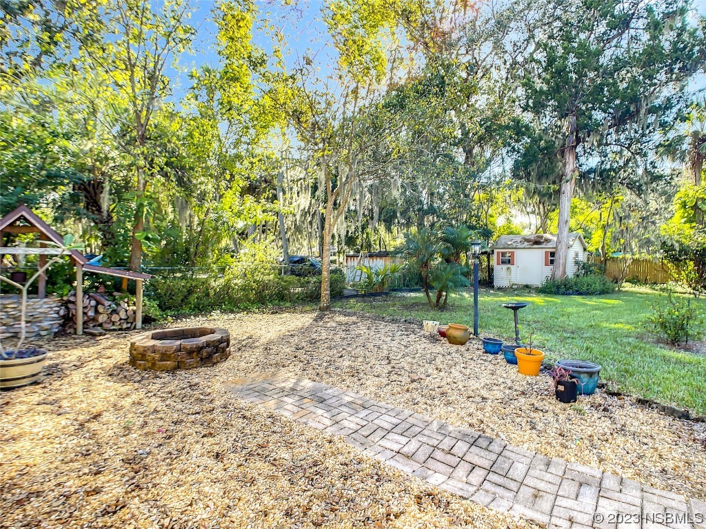 418 North Riverside Drive Edgewater, FL 32132 - Photo 40 of 48 a backyard of a house with table and chairs