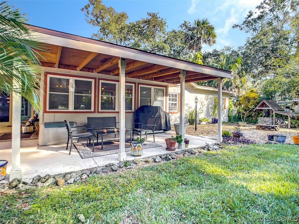 418 North Riverside Drive Edgewater, FL 32132 - Photo 42 of 48 a view of a house with backyard porch and sitting area