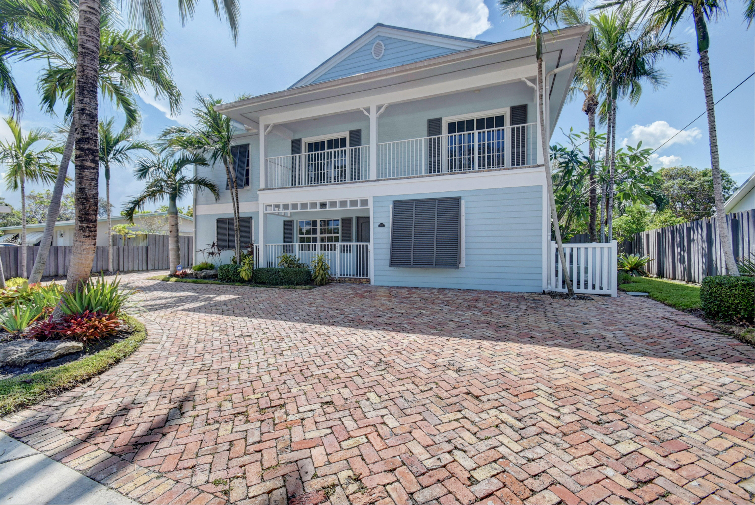 805 Northwest 2nd Avenue Boca Raton, FL 33432 - Photo 2 of 56 a front view of a house with a yard and potted plants