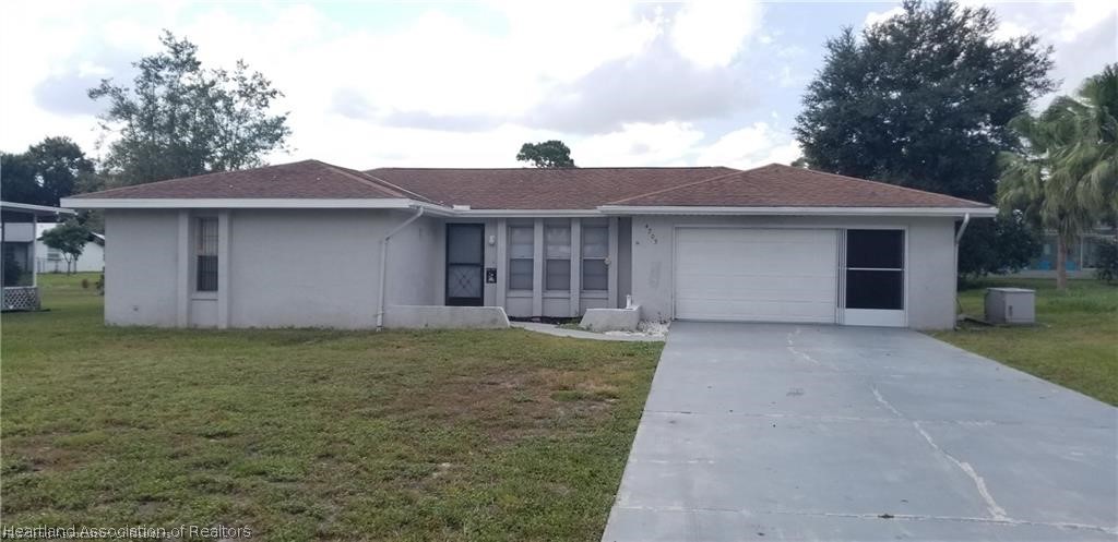 4203 Viscaya Street Sebring, FL 33872 - Photo 1 of 21 a front view of a house with garden