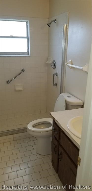 4203 Viscaya Street Sebring, FL 33872 - Photo 21 of 21 a white toilet sitting next to a bathroom sink