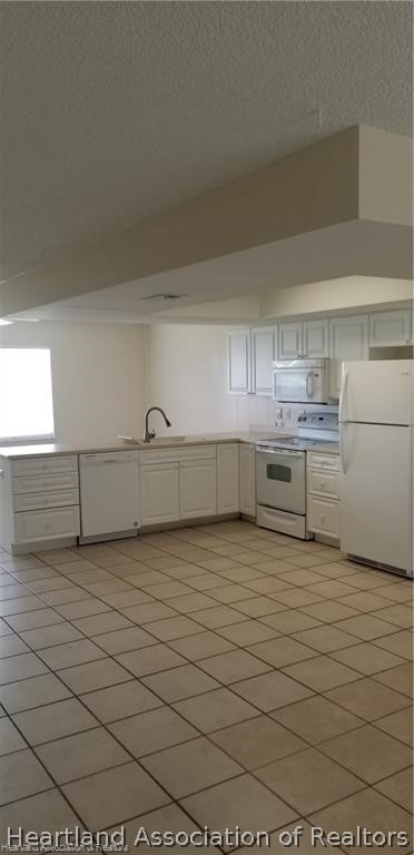 4203 Viscaya Street Sebring, FL 33872 - Photo 3 of 21 a view of a refrigerator in kitchen and an empty room