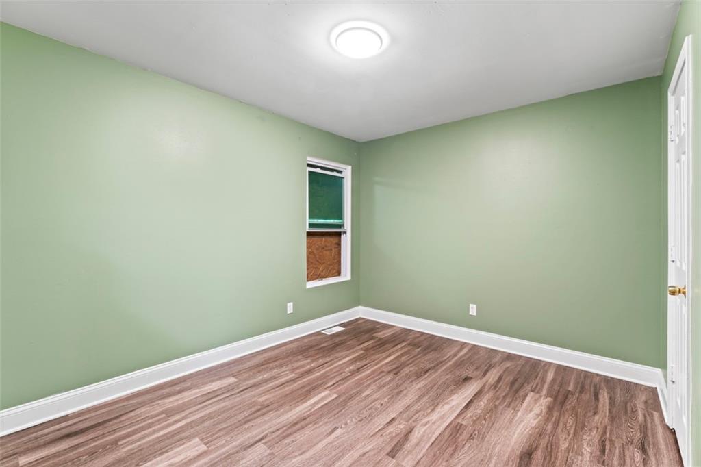 930 Hall Street Northwest, Unit A Atlanta, GA 30318 - Photo 11 of 31 an empty room with wooden floor and windows