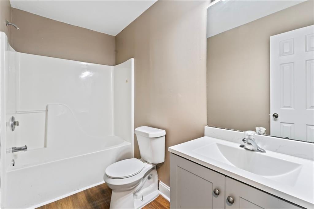 930 Hall Street Northwest, Unit A Atlanta, GA 30318 - Photo 16 of 31 a bathroom with a toilet sink and mirror