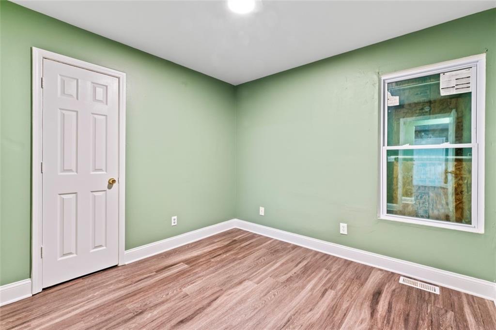 930 Hall Street Northwest, Unit A Atlanta, GA 30318 - Photo 17 of 31 an empty room with wooden floor and windows