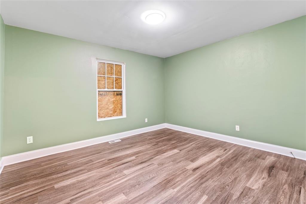 930 Hall Street Northwest, Unit A Atlanta, GA 30318 - Photo 18 of 31 an empty room with wooden floor and windows