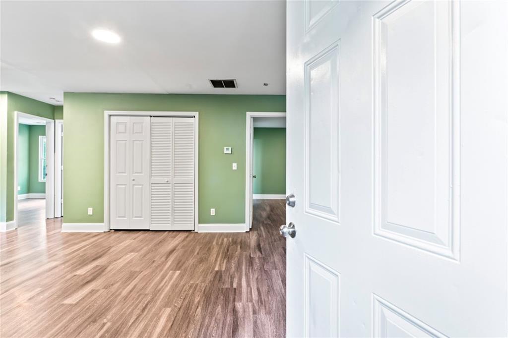 930 Hall Street Northwest, Unit A Atlanta, GA 30318 - Photo 19 of 31 a view of an empty room with wooden floor and a window