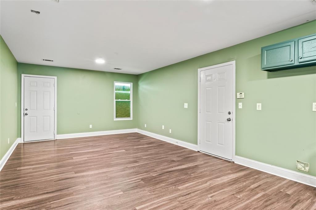 930 Hall Street Northwest, Unit A Atlanta, GA 30318 - Photo 20 of 31 a view of an empty room with wooden floor and a window