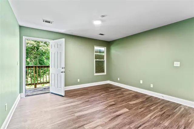 a view of balcony with deck and yard