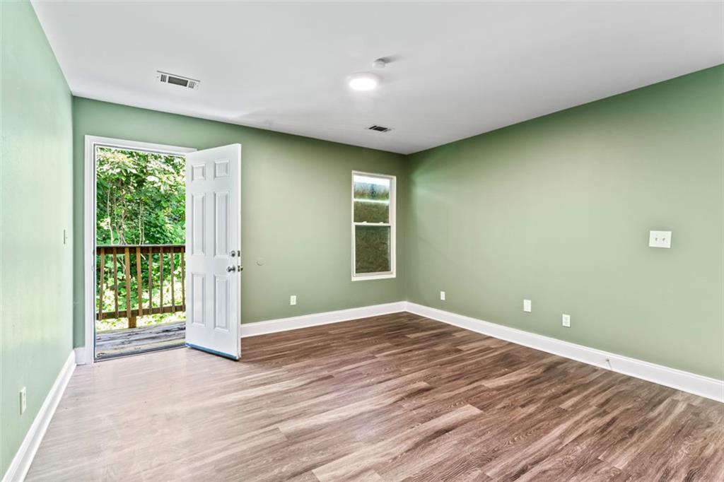 930 Hall Street Northwest, Unit A Atlanta, GA 30318 - Photo 22 of 31 a view of an empty room with wooden floor and a window