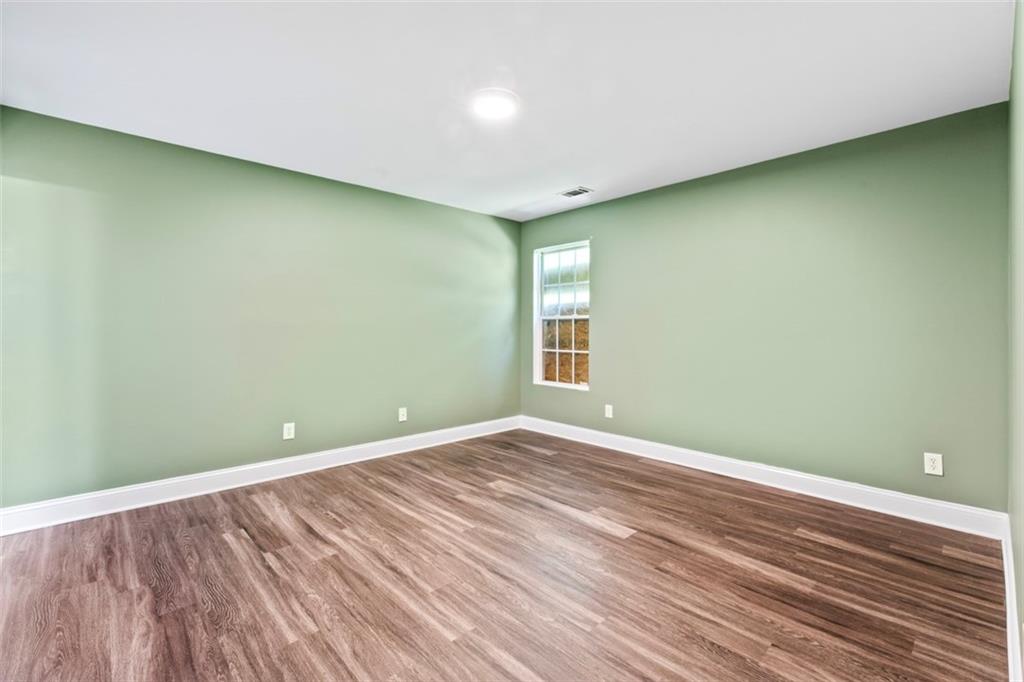 930 Hall Street Northwest, Unit A Atlanta, GA 30318 - Photo 24 of 31 a view of empty room with wooden floor and fan