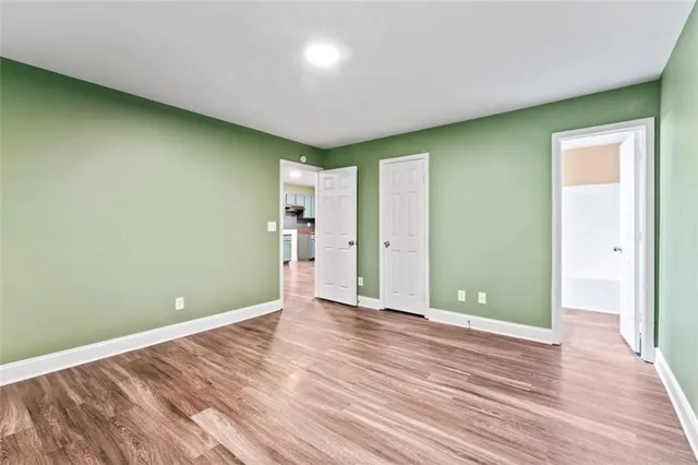 a bathroom with a granite countertop sink toilet mirror and shower
