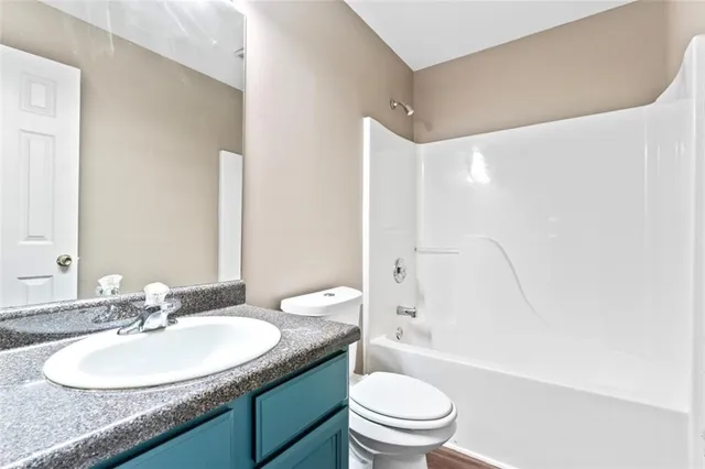 a kitchen with stainless steel appliances granite countertop a refrigerator sink and cabinets