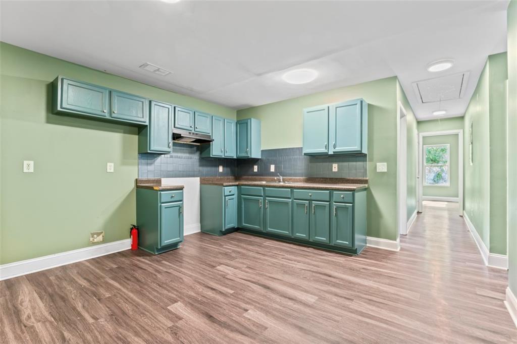 930 Hall Street Northwest, Unit A Atlanta, GA 30318 - Photo 27 of 31 a kitchen with stainless steel appliances granite countertop a refrigerator sink and cabinets