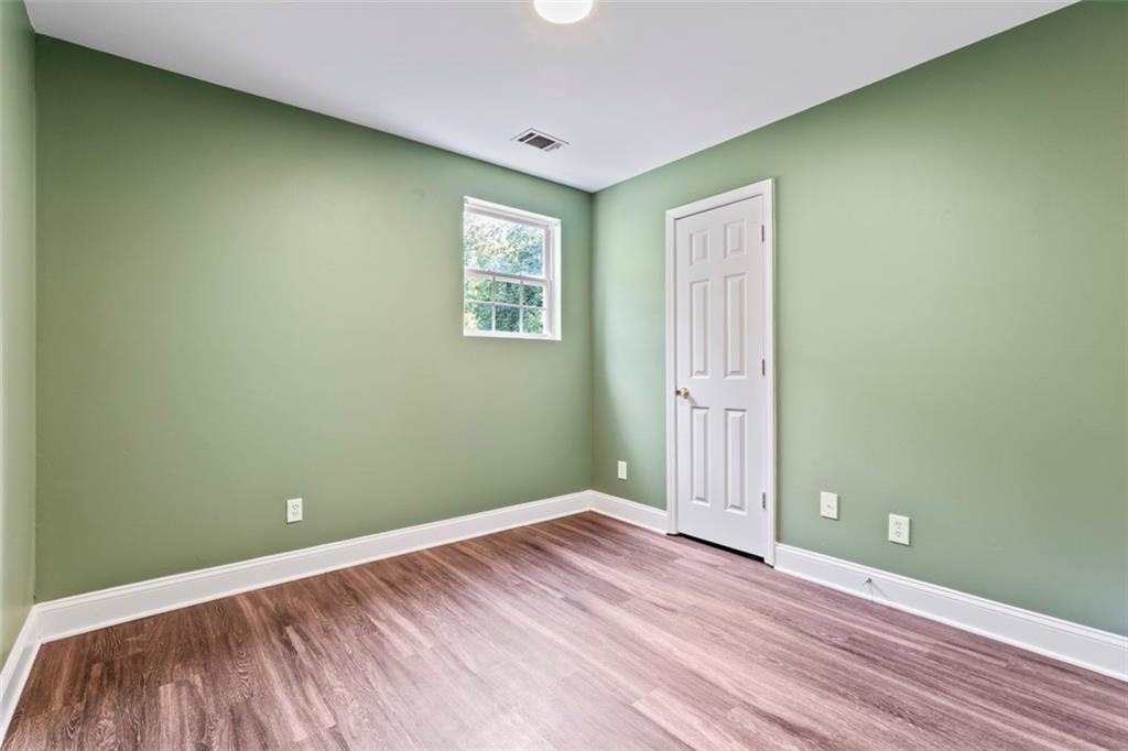 930 Hall Street Northwest, Unit A Atlanta, GA 30318 - Photo 28 of 31 an empty room with wooden floor and windows