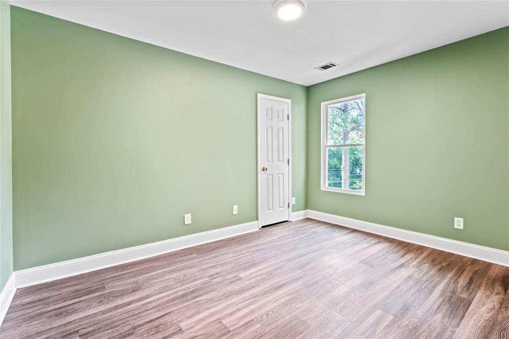 930 Hall Street Northwest, Unit A Atlanta, GA 30318 - Photo 30 of 31 an empty room with wooden floor and windows