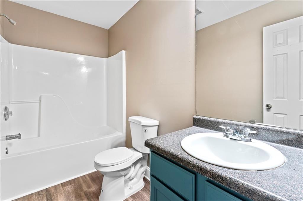 930 Hall Street Northwest, Unit A Atlanta, GA 30318 - Photo 31 of 31 a bathroom with a granite countertop sink toilet and shower