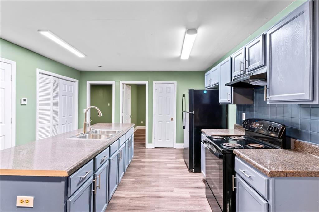 930 Hall Street Northwest, Unit A Atlanta, GA 30318 - Photo 8 of 31 a kitchen with stainless steel appliances granite countertop a stove a sink dishwasher a refrigerator and a oven