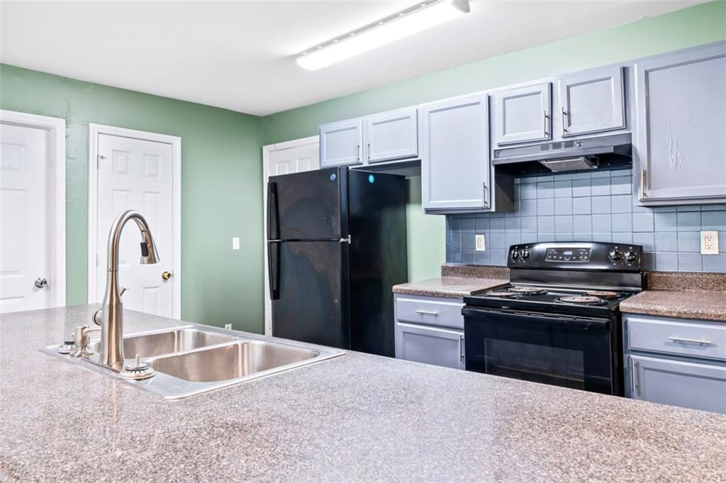 930 Hall Street Northwest, Unit A Atlanta, GA 30318 - Photo 9 of 31 a kitchen with stainless steel appliances granite countertop a sink stove and refrigerator