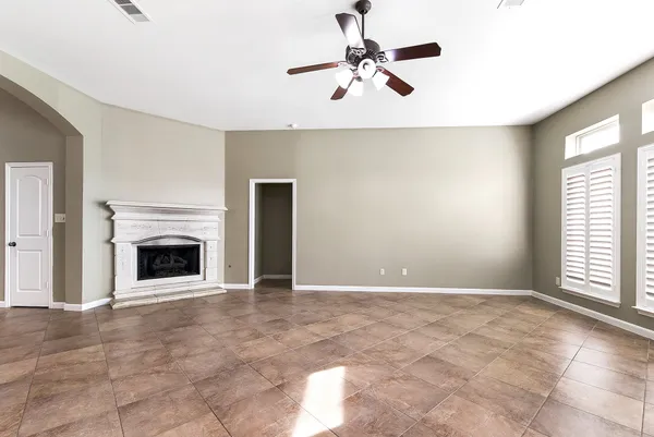 a view of a livingroom with a fireplace and a window