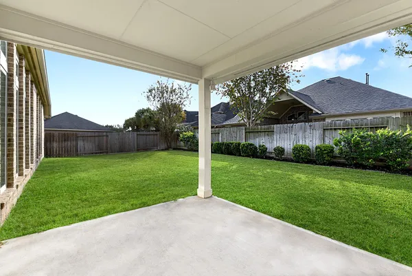 a view of a house with a yard and sitting area